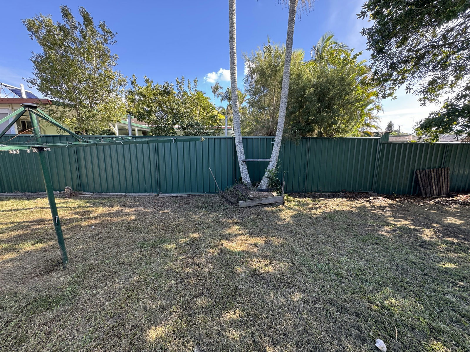 The same back corner at Waterford West cleared of debris with the grass cut back to the boundary fence