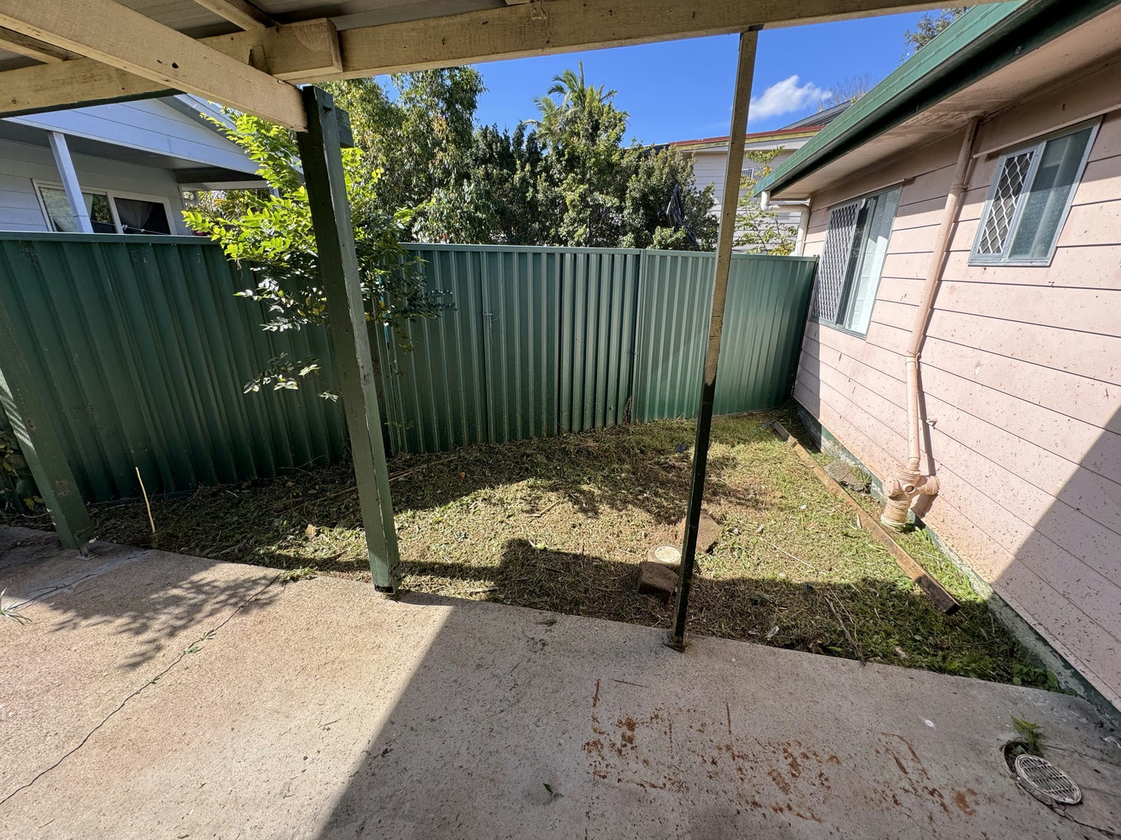 The Waterford West carport area cleared, swept and accessible after the clean-up